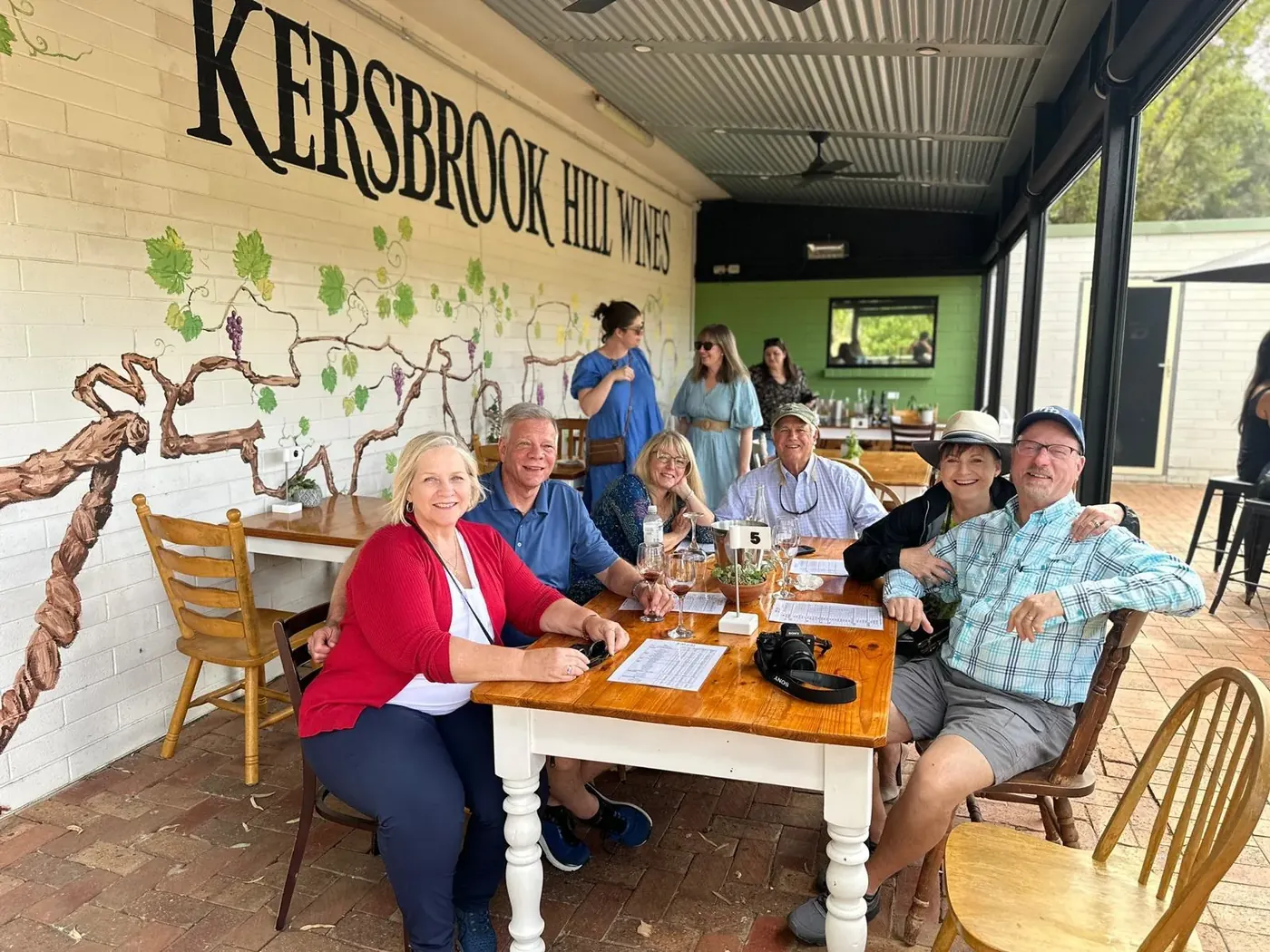 Guests seated at a timber table inside the Kersbrook Hill Wines cellar door