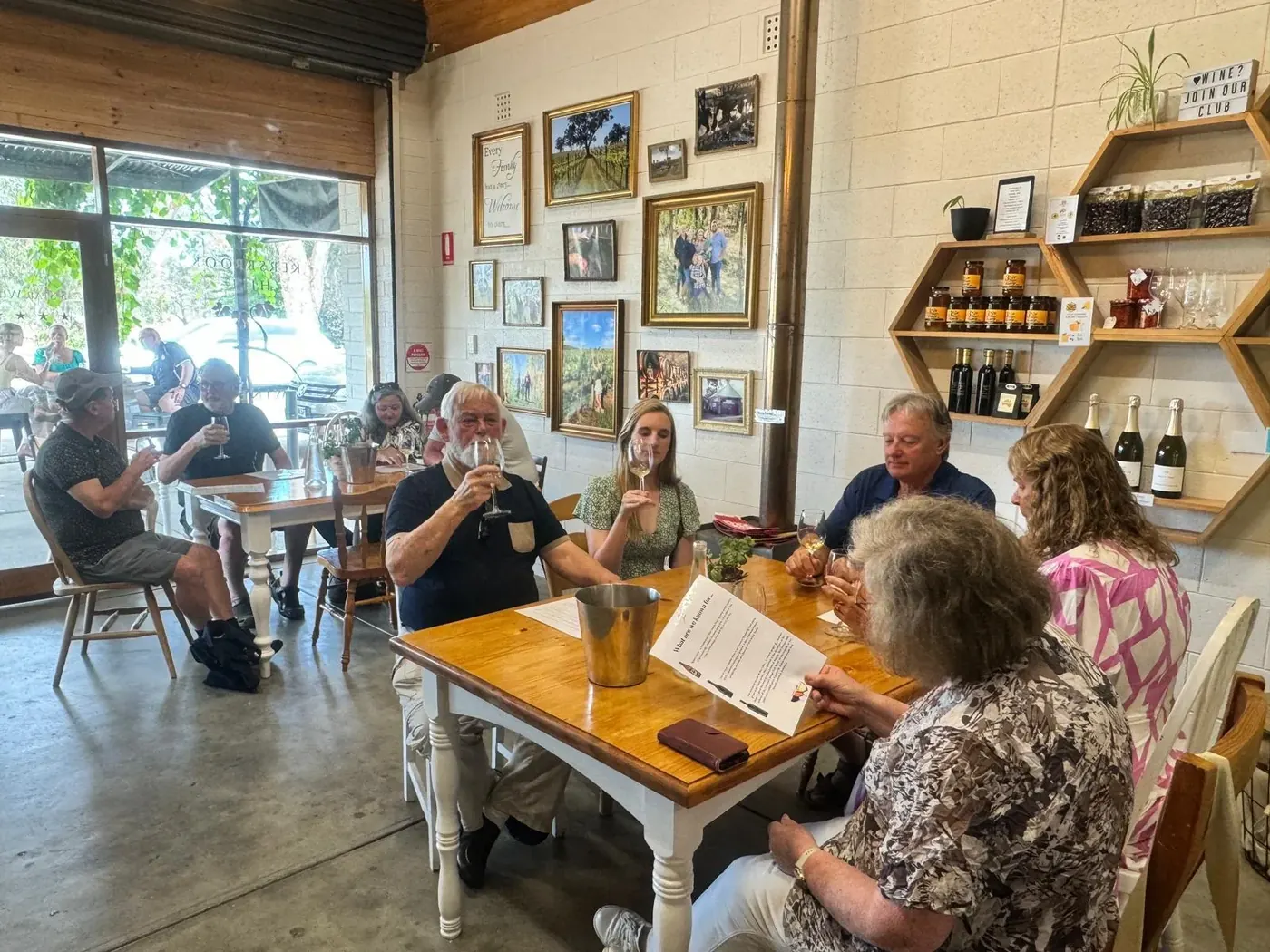 Guests tasting at a farmhouse table inside the Chateau Dorrien cellar door