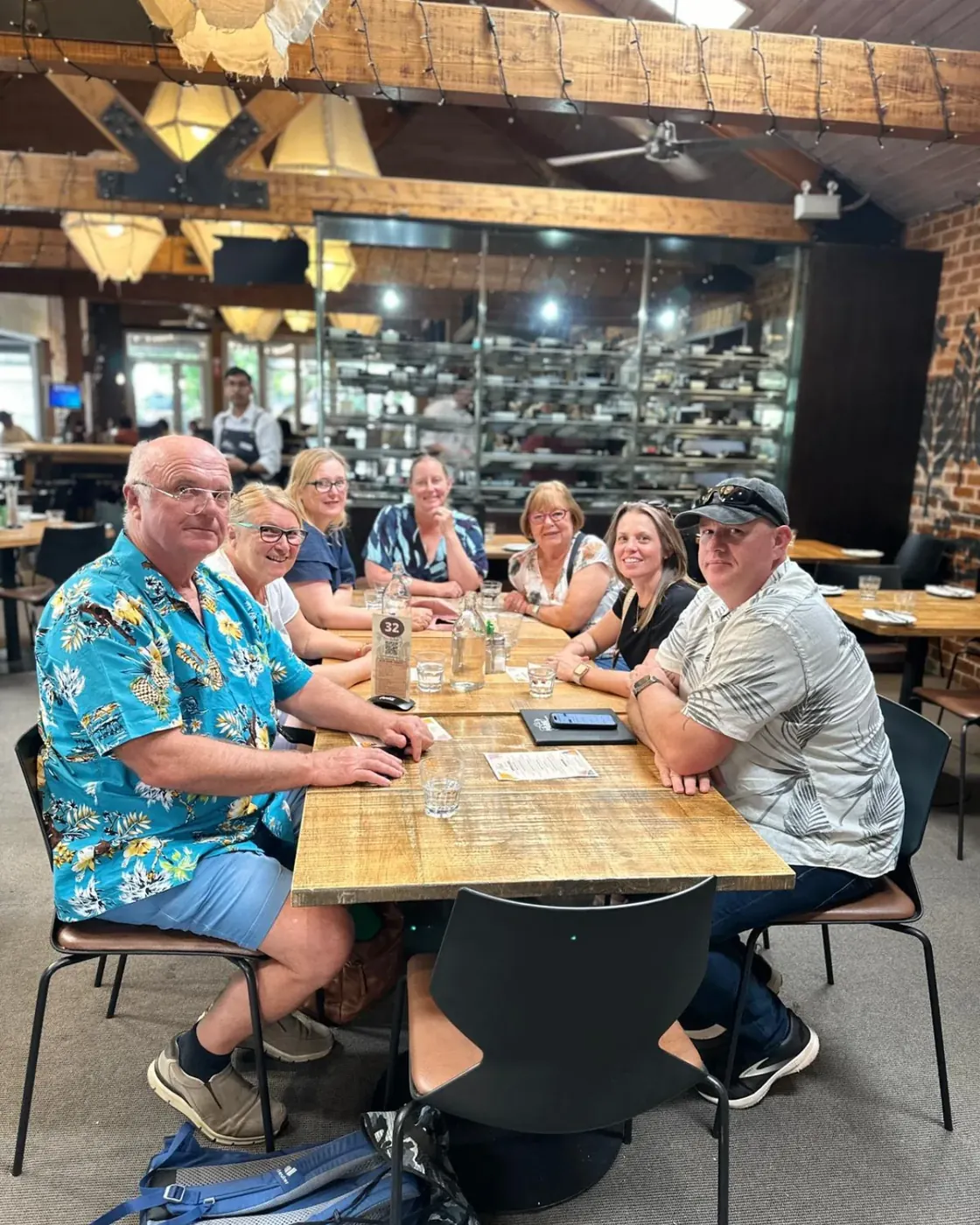 Tour group seated around a cafe table in Hahndorf before lunch