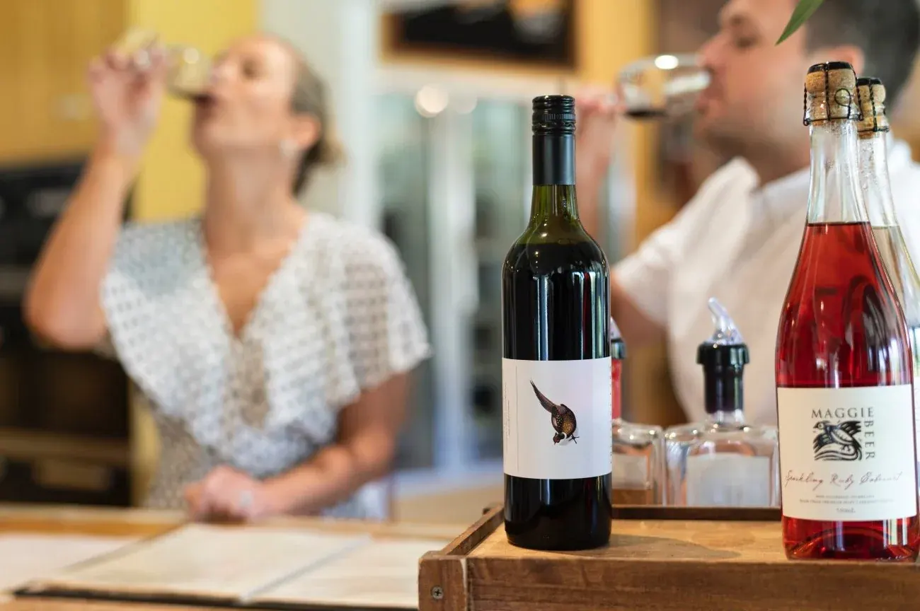Two guests tasting Pheasant Farm shiraz and rose at the Farm Shop counter
