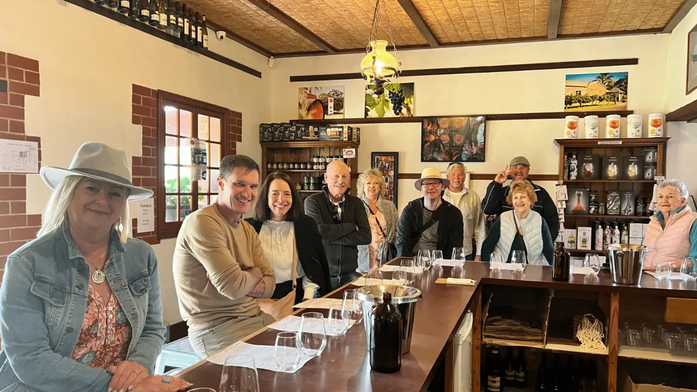 Cellar-door tasting bench set with glasses and open bottles for a seated Barossa flight