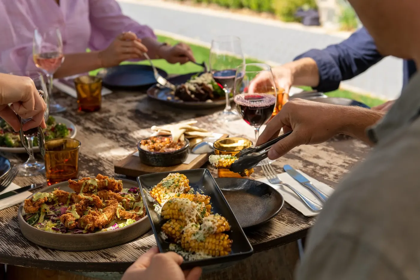 Shared platters and glasses of Barossa red spread across a restaurant table